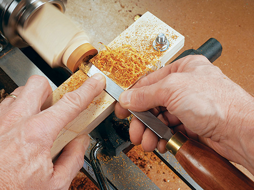 Setting up scraper for ring interior on lathe jig