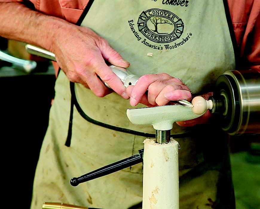 The author then grabs the tenon with a four-jaw chuck and finishes the face of the knob.