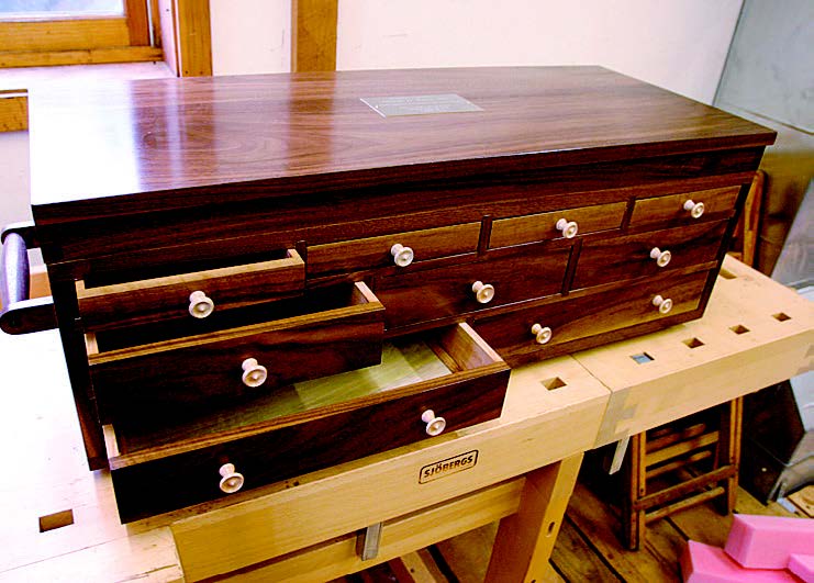 The author built this tool chest in 2004 for the retiring head of surgery at a hospital. It has both turned knobs and stout handles at each end.