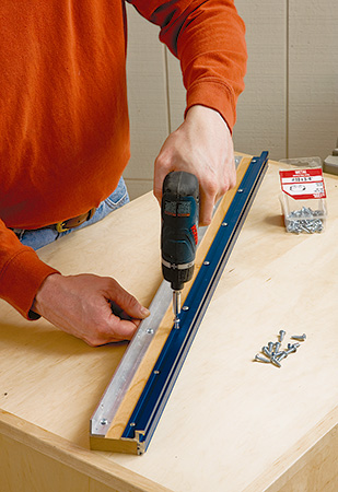 Screwing saw fence together for installation on miter saw stand