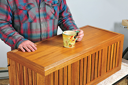 Holding Ottoman chest lid in place with coffee cup