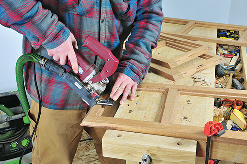Using biscuit joiner to cut joinery for Ottoman chest panel
