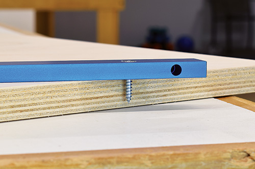 Checking screw length against plywood depth