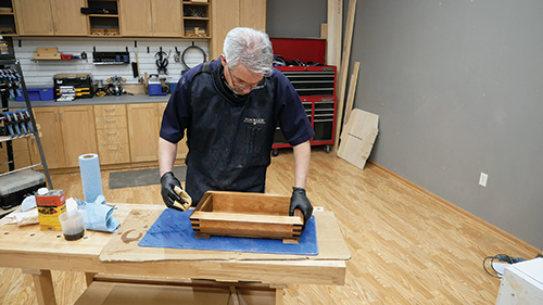 Rubbing Waterlox finish into exterior of walnut cherry tray