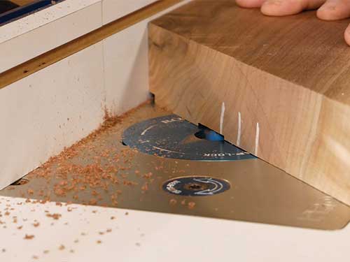 Routing groove in walnut tabletop lumber for inlay