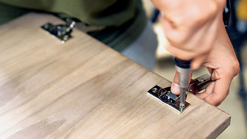 Installing cup hinges in walnut storage cabinet