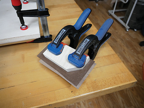 Clamping veneer to waterfall desk corners