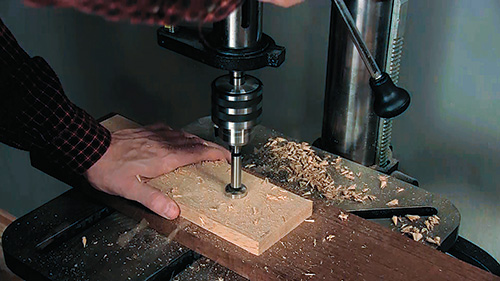 Boring pipe hole in red oak board