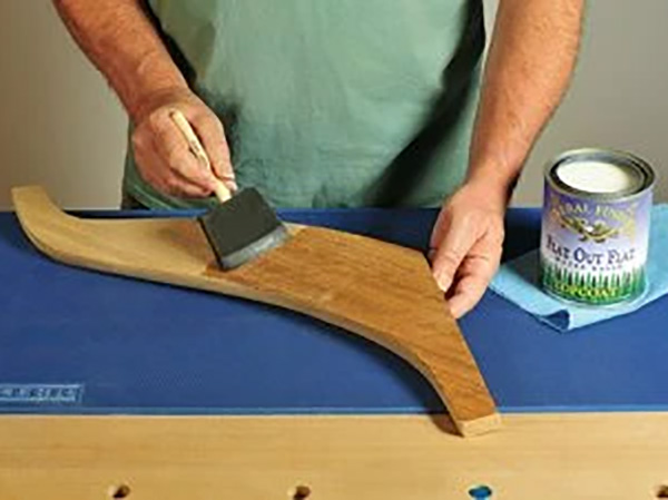 Wiping water-based finish on table leg