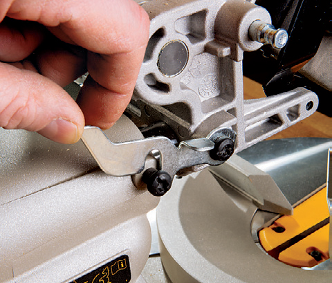 DeWALT provides a stop lever that parks the motor carriage at the optimal location for cutting tall moldings against the fence, “chop saw” style.