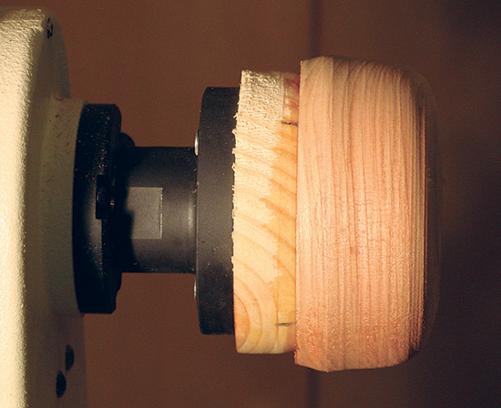 Old-school faceplate turning often involves gluing your turning stock (here, a piece of cherry) to a sacrifical piece of wood (in the photo, a piece of pine) that is, in turn, screwed to the faceplate.