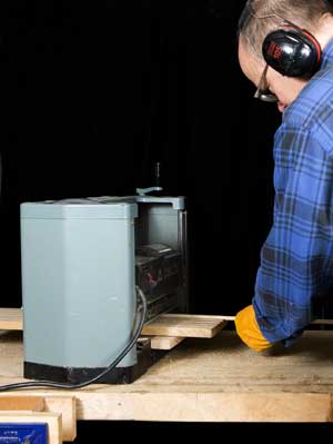 Running bamboo through planer on jig.