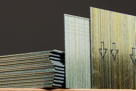 There are two pin nail styles: “slight-head” brads (center) offer a tad more holding power than headless pins (right). Nailers that shoot slight-head will also shoot headless, making them a bit more versatile than guns that only shoot headless.