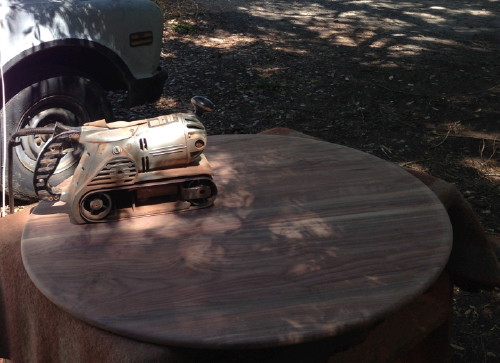 The belt sander used on the table tops is a classic. The sheer weight of the beast does all the work for you. But when you pull the trigger on that thing, you better hold on to it or it will fly off your work! In the background of this photo you can see where the lagoon is across the road.