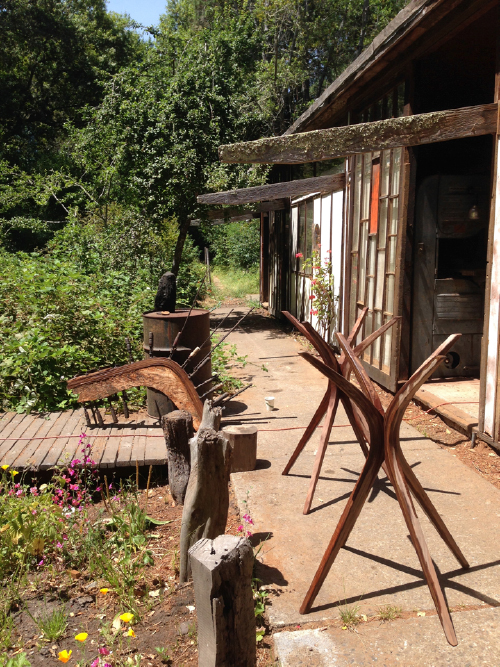 Here are two of the tables after wetting for the final sanding (knocking the whiskers off) before applying finish. In the background, is a leg lamination drying with glue.